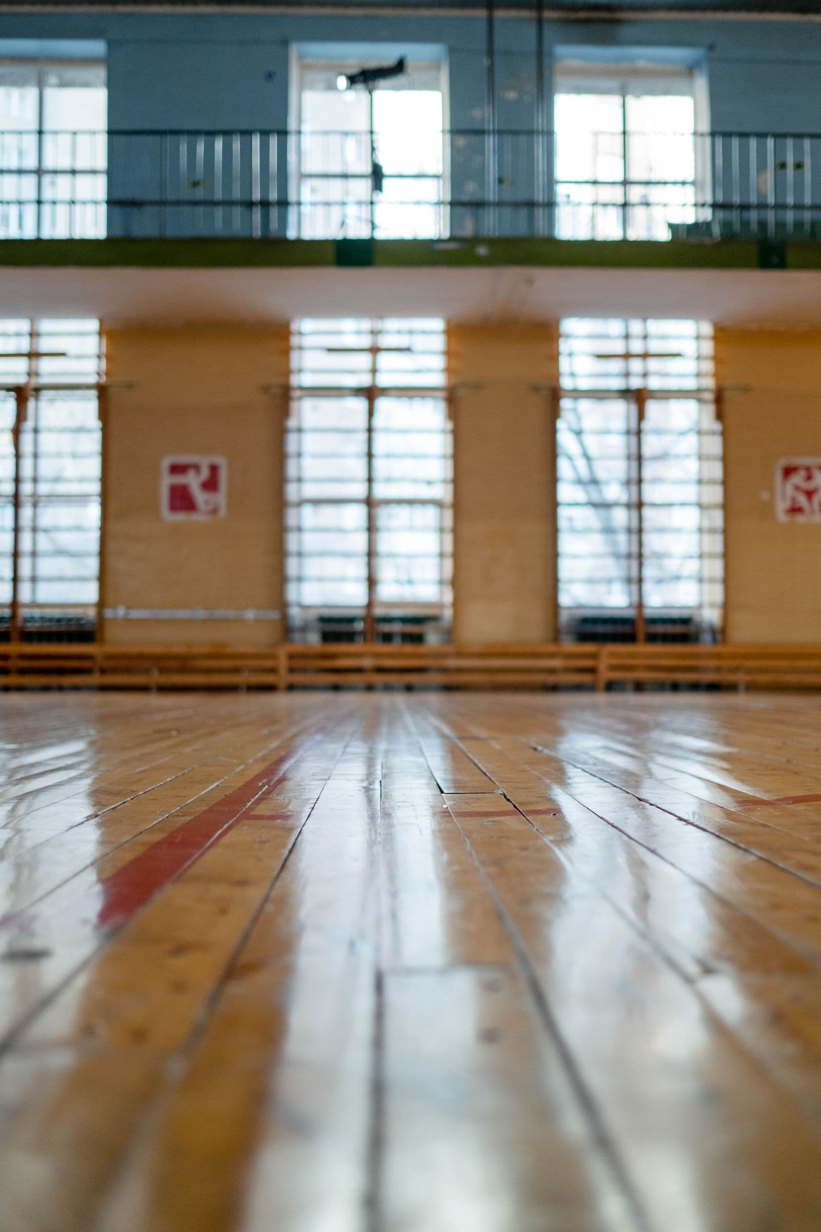 Sunlit gym floor with polished surface and equipment